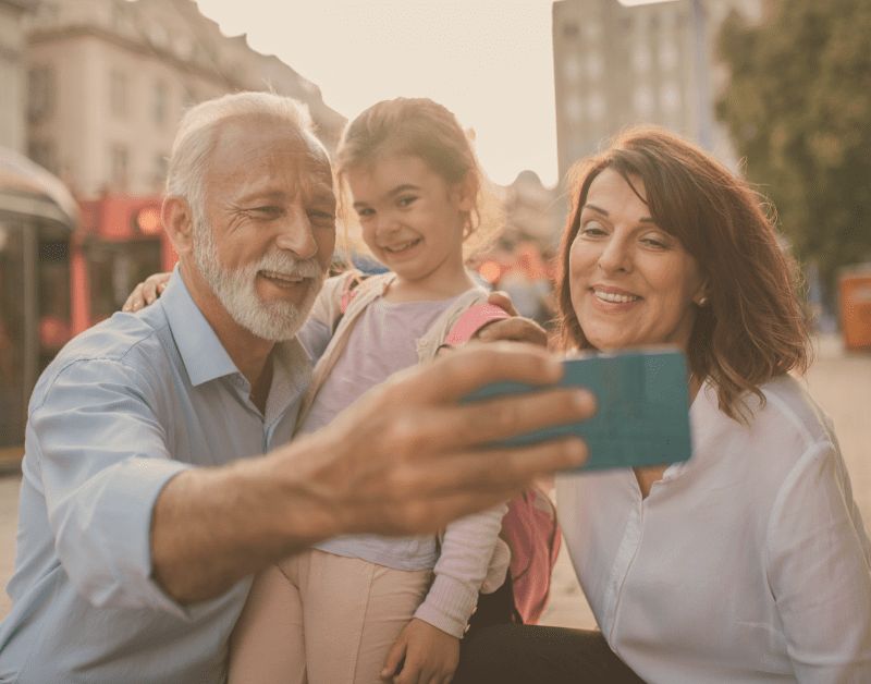 older couple taking selfie with granddaughter