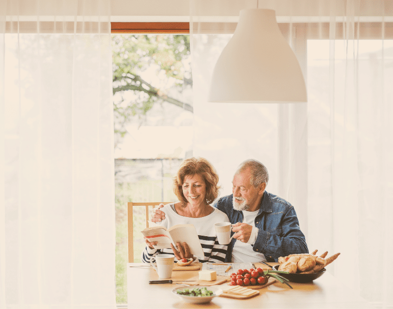 man and woman enjoying breakfast together at the dining room table