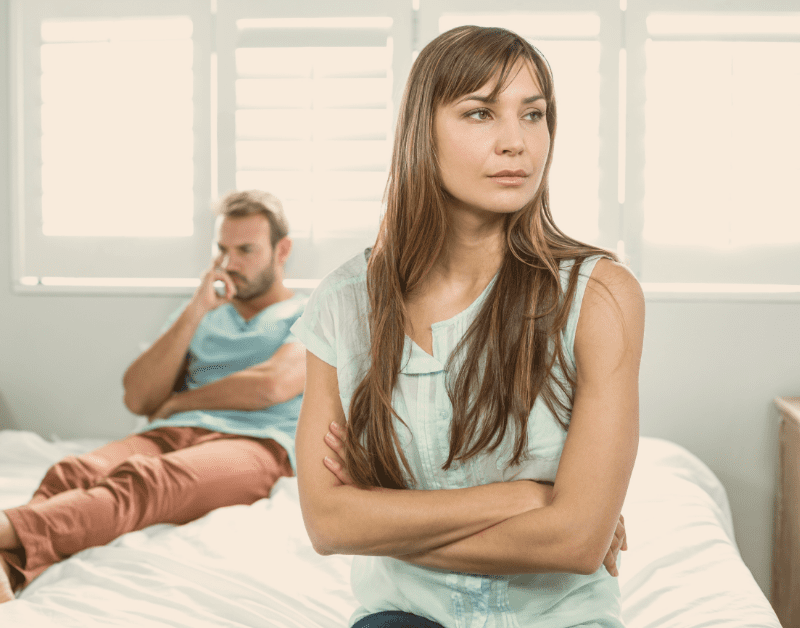 man and woman in bedroom not talking and not happy with each other