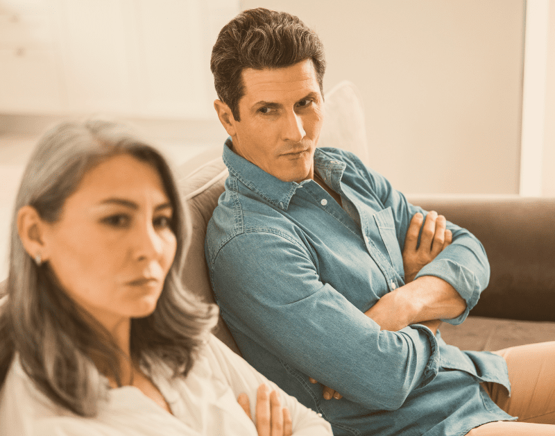 man and woman sitting together angry not talking
